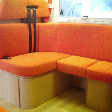 Zona dinette ad angolo con poggiatesta e sedute fronte guida dotate di cinture di sicurezza.